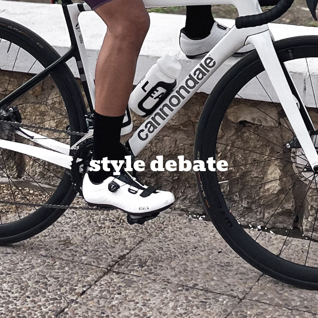 A cyclist showcasing a retro-inspired outfit with black socks paired with white cycling shoes, demonstrating modern kit coordination and stylish cycling aesthetics.